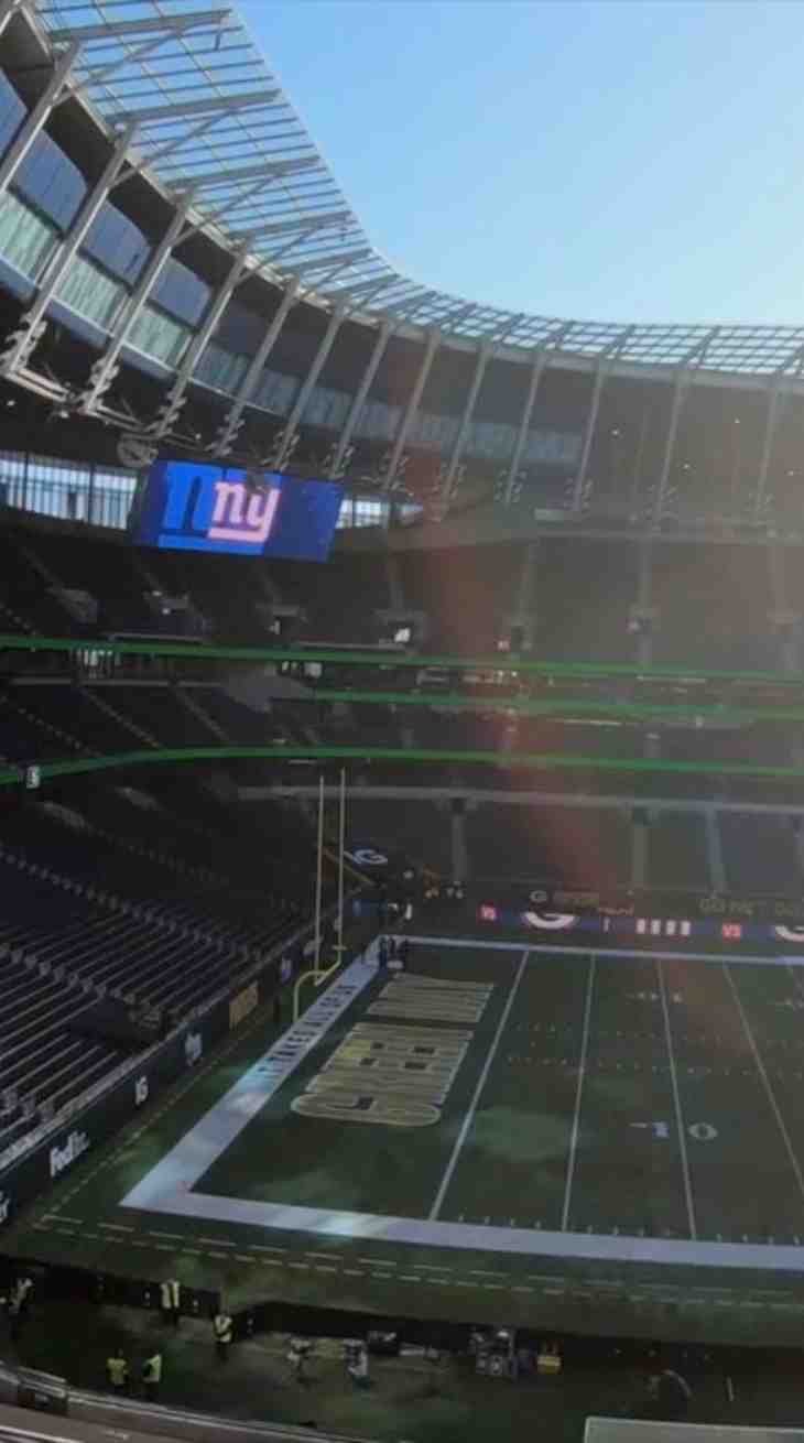 Wide angle shot of a stadium, with sun streaming in