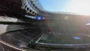 Wide angle shot of a stadium, with sun streaming in
